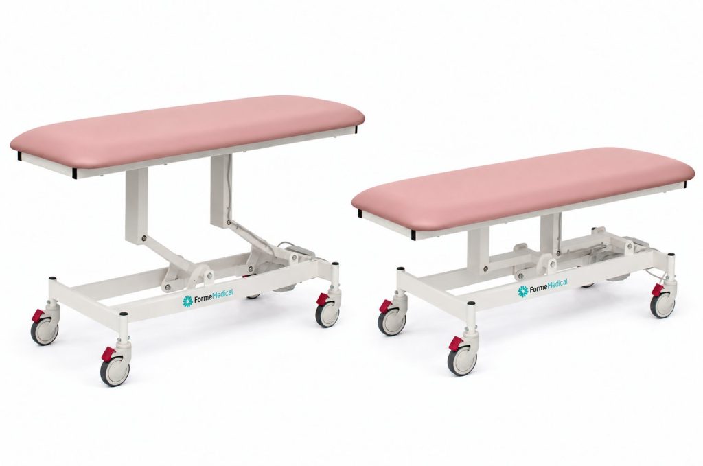 Forme Medical Jasper treatment table in pink, shown raised and lowered